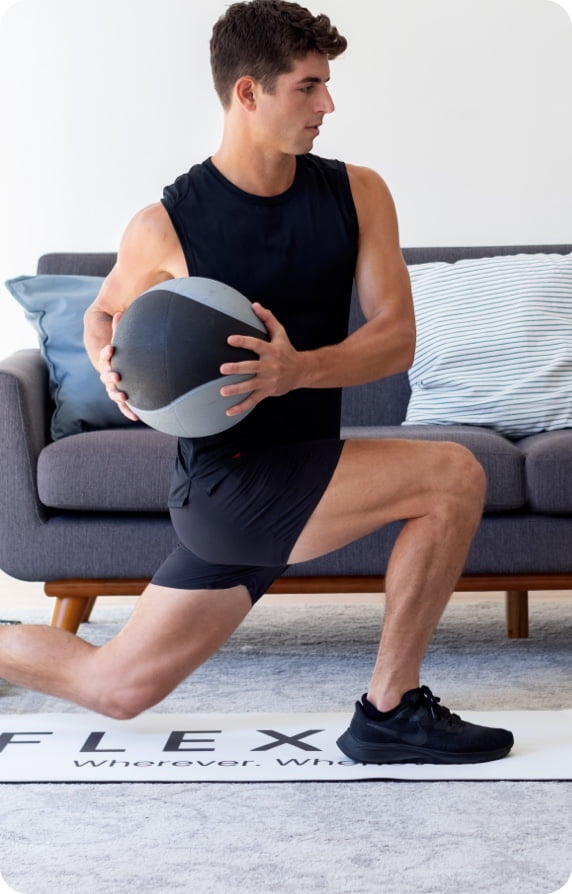man doing lunge with a medicine ball